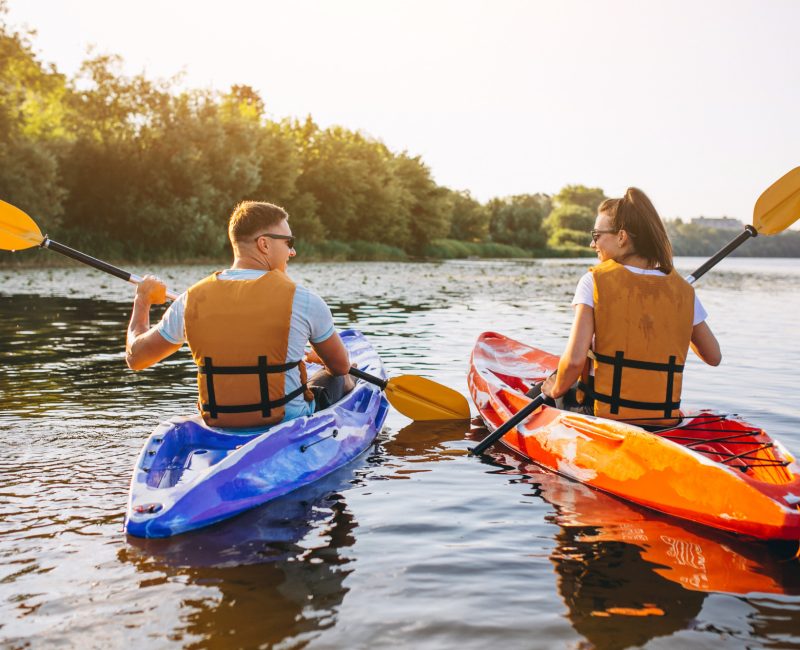 couple-together-kayaking-river